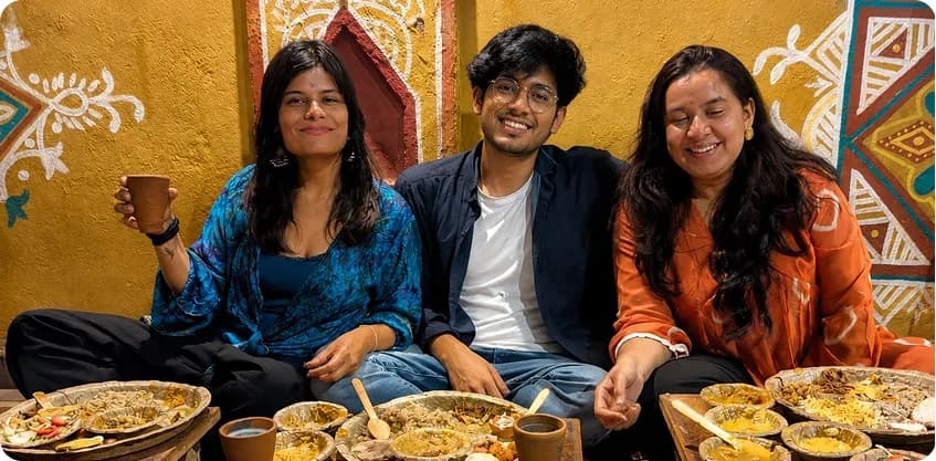 Friends sharing a traditional village thali meal together