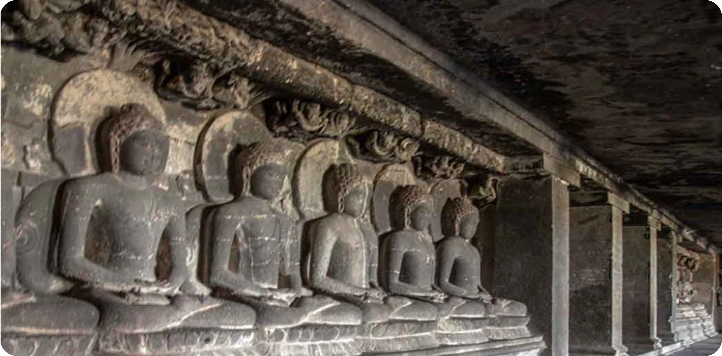 Buddha statues carved into the rock at Cave 12 of the Ellora Caves in Maharashtra, India.