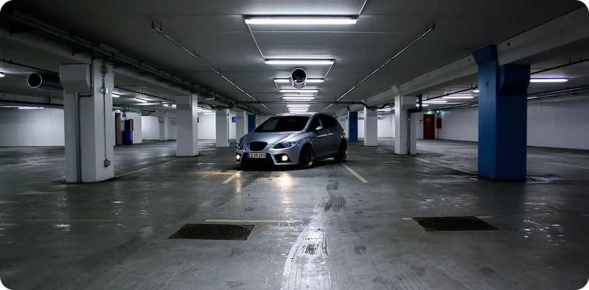 Personal car sitting unused in an underground parking garage