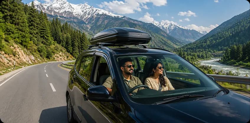 Couple on a self-drive SUV road trip through scenic mountains with snow-capped peaks