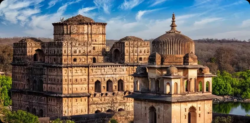 Historic sandstone palaces and domed cenotaphs along the river in Orchha
