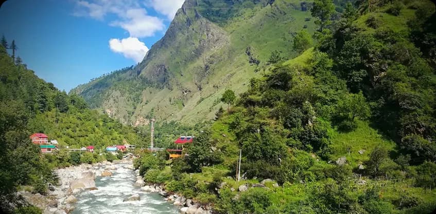 Tirthan Valley river flowing through a green Himalayan mountain landscape