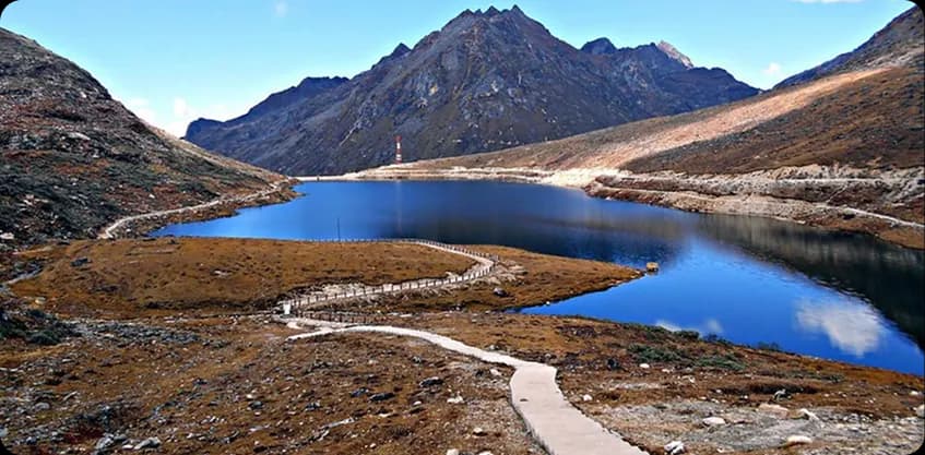 High-altitude blue alpine lake surrounded by rugged mountains near Ziro Valley